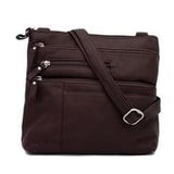 Osgoode Marley large black crossbody traveler bag with adjustable strap and multiple compartments, designed for travel and everyday use.