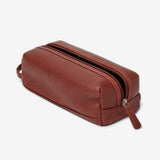 Small leather travel kit from Osgoode Marley, a compact toiletry bag with a sleek leather exterior and organized interior.