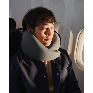 Forest green Ostrichpillow Go neck pillow, a comfortable travel accessory with soft fabric and ergonomic design.