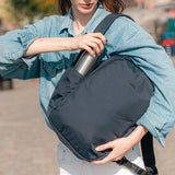 Pacsafe V 16L anti-theft backpack with padded straps, multiple compartments, and sleek black design for everyday use