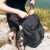 Pacsafe EXP35 anti-theft travel backpack in black with padded shoulder straps and multiple compartments for secure travel storage.