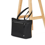 Pacsafe anti-theft carryall tote bag in black with padded handles and secure zippers, designed for everyday use.