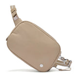 Pacsafe anti-theft micro sling bag in black with adjustable strap and secure zippers, designed for compact everyday use.