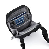 Blue Pacsafe RFID blocking tech crossbody bag with adjustable strap and multiple compartments for secure, organized carrying.
