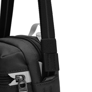Pacsafe GO anti-theft micro crossbody bag in black with adjustable strap and secure zipper closure, designed for daily use.