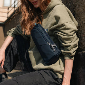 Pacsafe V Anti-Theft Action Sling Pack in black with adjustable strap and multiple compartments for secure carrying.