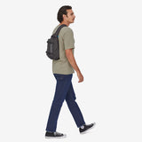 Black Patagonia Atom Sling Bag 8L with adjustable strap and compact design, ideal for lightweight carrying and outdoor activities.