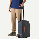 Patagonia Black Hole® MLC® Wheelie luggage with black durable fabric, multiple wheels, and a spacious design for travel.
