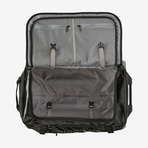 Open Patagonia Black Hole® Wheeled Duffel Bag 40L showing spacious interior and durable black fabric with wheels and handle.