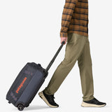 Patagonia Black Hole® wheeled duffel bag in black, 40L, with sturdy wheels and adjustable shoulder strap for travel storage.