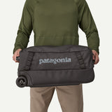 Patagonia Black Hole Wheeled Duffel Bag 40L in black, featuring durable fabric, wheels, and a sturdy handle for travel.