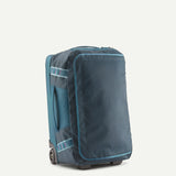 Patagonia Black Hole Wheeled Duffel Bag 40L in black, showing sturdy wheels, retractable handle, and spacious main compartment.