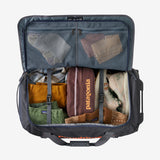 Patagonia Black Hole® Wheeled Duffel Bag 70L, black with zipper compartments and sturdy wheels for travel and storage.