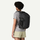Patagonia Refugio Daypack 26L in black with multiple compartments and padded shoulder straps, suitable for commuting and outdoor use.