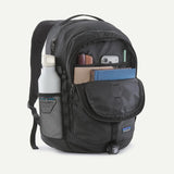 Patagonia Refugio Daypack 26L with multiple compartments and padded shoulder straps, shown on a person outdoors.