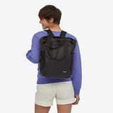 Patagonia Ultralight Black Hole® Tote Pack 27L in black, showing durable water-resistant nylon material with tote handles.