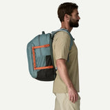 Patagonia Refugio Daypack 32L in black, showing the front view with multiple compartments and padded shoulder straps.