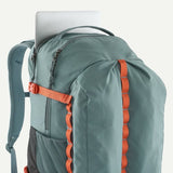 Patagonia Refugio Daypack 32L with multiple compartments, black color, and padded shoulder straps for comfortable carrying.