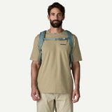 Patagonia Refugio Daypack 32L in black with padded shoulder straps, front pocket, and side mesh compartments for outdoor use.