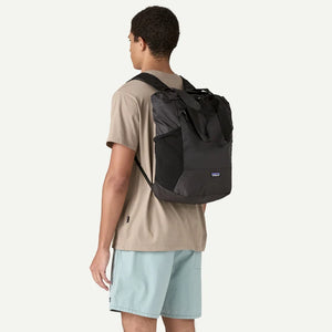 Patagonia Terravia Tote Pack 24L in black fabric, showing the lightweight, foldable tote with adjustable shoulder straps.