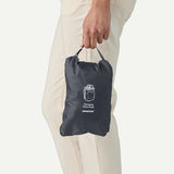 Patagonia Terravia Tote Pack 24L, eco-friendly reusable bag with shoulder straps, shown in a natural outdoor setting.