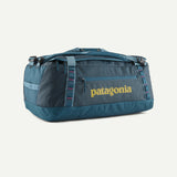 Patagonia Black Hole 55L duffel bag made of durable black fabric with handles and a zippered main compartment.