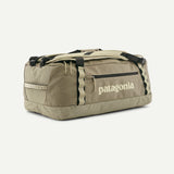 Patagonia Black Hole 55L duffel bag in black fabric with adjustable shoulder strap and zippered main compartment.