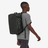 Black Patagonia Black Hole Duffel Bag 40L with carrying straps and durable material, ideal for travel and outdoor adventures.