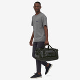 Patagonia Black Hole 40L duffel bag in black, showing durable fabric and adjustable shoulder strap for travel and storage.