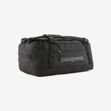 Patagonia Black Hole 40L duffel bag in black, showing durable fabric, zipper closure, and carry handles for travel and storage.
