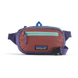 Patagonia Ultralight Black Hole Mini Hip Pack 1L in patchwork Subtidal Blue with logo patch, compact and lightweight for on-the-go storage.