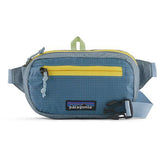 Patagonia Ultralight Black Hole Mini Hip Pack in patchwork subtidal blue with logo patch, compact 1L size for outdoor carrying.