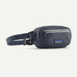 Patagonia Ultralight Black Hole® Mini Hip Pack in patchwork Subtidal Blue with logo patch, compact and lightweight for outdoor use.