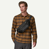 Shiny black Patagonia Black Hole® Waist Pack 5L with adjustable strap and zippered pocket for convenient carrying