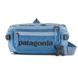 Black Patagonia Black Hole® Waist Pack 5L with shiny black fabric, compact and versatile for outdoor activities and daily use.