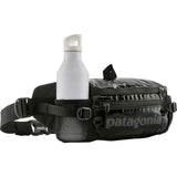 Shiny black Patagonia Black Hole® Waist Pack 5L with adjustable strap and zippered compartments for outdoor storage.
