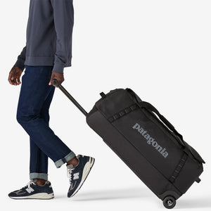 Black Patagonia Black Hole® Matte Wheeled Duffel 100L with sturdy wheels and durable matte black fabric for travel and storage.