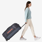 Patagonia Black Hole® Matte Wheeled Duffel 100L in black, showing sturdy wheels and spacious carry handles.