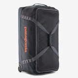 Patagonia Black Hole® Matte Wheeled Duffel 100L, durable black travel bag with wheels and sturdy handles for easy transport.