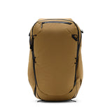 Peak Design Travel Backpack 45L in Coyote color, showing spacious main compartment and adjustable straps on a sleek outdoor setting.