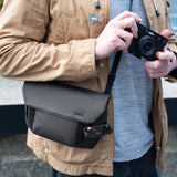 Black Peak Design Field Pouch V2 with multiple compartments and adjustable strap for versatile carrying and organization.