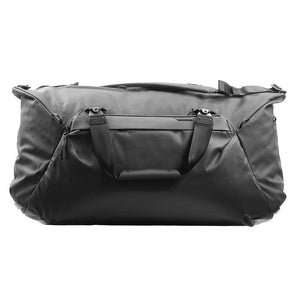 Black Peak Design Travel Duffel 65L with multiple zip compartments and padded shoulder strap, showcasing its spacious design.