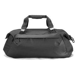 Black Peak Design Travel Duffel 65L with sturdy handles and adjustable shoulder strap, showing spacious main compartment.