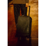 Peak Design Roller Pro Carry-On luggage in sage color, showing the sleek exterior with adjustable handle and durable wheels.