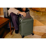 Peak Design Roller Pro Carry-On luggage in sage color, showing the sleek, durable carry-on bag with wheels and handle.