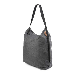 Peak Design packable tote bag folded flat, showing compact storage and durable fabric for versatile carrying options.