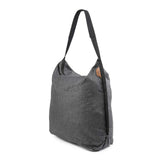 Peak Design packable tote bag folded flat, showing compact storage and durable fabric for versatile carrying options.