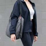 Peak Design packable tote bag shown folded and expanded, lightweight and versatile for daily use or travel.