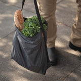 Peak Design packable tote bag shown folded and unfolded, lightweight and versatile for everyday carry and travel.