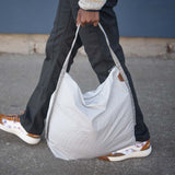 Peak Design packable tote bag folded and open, showcasing lightweight, durable nylon material and spacious interior for versatile use.